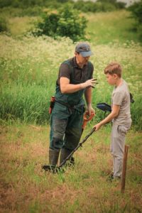 Man and bot metal detecting